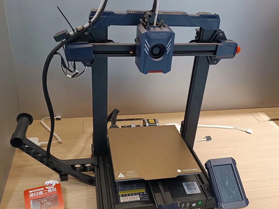 An Anycubic Kobra 2 Pro bed-slinger on a store display shelf, with a red price tag beside its frame.