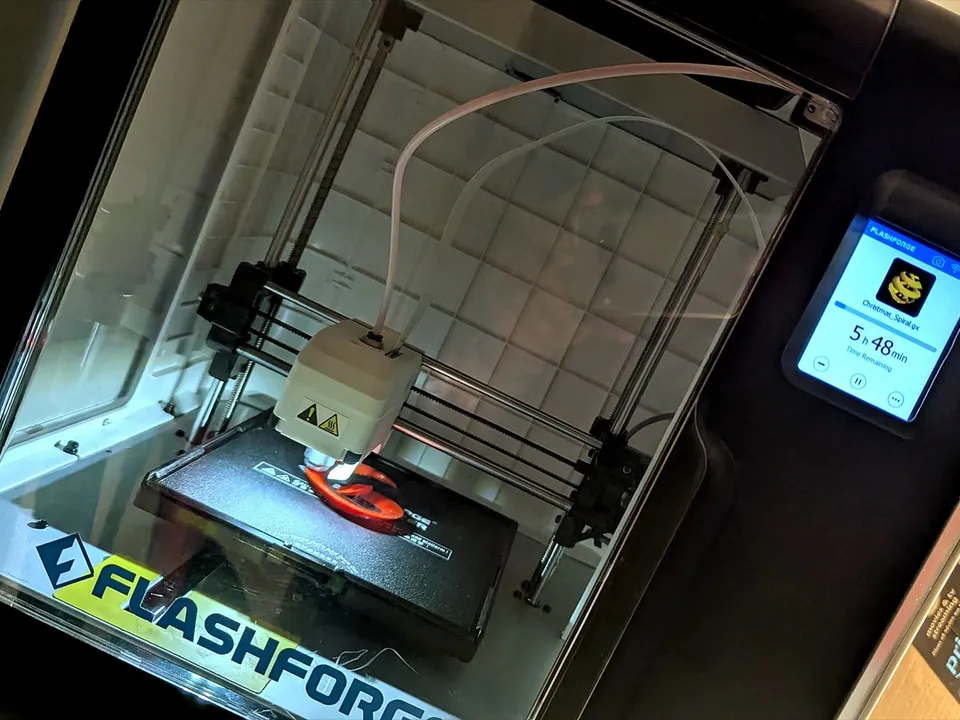 A Flashforge Adventurer 3 enclosed printer mid-print, its touchscreen showing 5 h 48 min remaining.